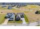 Aerial view of two beautiful modern homes on a well manicured lawn, with a tree-lined street at 16392 Grand Cypress Dr, Noblesville, IN 46060