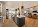 This large open-concept kitchen features an island with seating, stainless steel appliances, and ample storage at 16392 Grand Cypress Dr, Noblesville, IN 46060