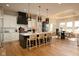 This gourmet kitchen features an island with counter seating, pendant lights, and stainless steel appliances at 16392 Grand Cypress Dr, Noblesville, IN 46060