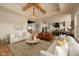 Open-concept living room and kitchen with hardwood floors, modern lighting, and ample seating at 16392 Grand Cypress Dr, Noblesville, IN 46060