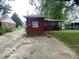 View of the backyard and driveway leading to the back of the home at 1925 N Leland Ave, Indianapolis, IN 46218