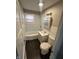 Bathroom with a tub, vanity with a medicine cabinet, toilet, and light fixture at 1925 N Leland Ave, Indianapolis, IN 46218