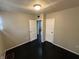 An additional angle of the bedroom showcasing two standard doors, neutral walls, and dark hardwood flooring at 1925 N Leland Ave, Indianapolis, IN 46218