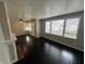 Bright living room with dark hardwood flooring, a fireplace, and lots of natural light at 1925 N Leland Ave, Indianapolis, IN 46218