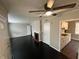 Inviting living room features black flooring, a ceiling fan, and a fireplace at 1925 N Leland Ave, Indianapolis, IN 46218