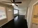Bright living room with dark hardwood flooring, a fireplace, and view into the kitchen at 1925 N Leland Ave, Indianapolis, IN 46218