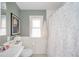 Stylish bathroom with a shower, pedestal sink, and attractive tile and paint at 208 Northshore Blvd, Anderson, IN 46011