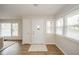 Welcoming foyer with a glass-paneled front door and lots of natural light from large windows at 208 Northshore Blvd, Anderson, IN 46011