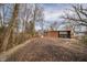 A single-story brick home with a charming front patio and a large driveway at 208 Northshore Blvd, Anderson, IN 46011
