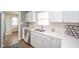Modern kitchen features stainless steel appliances, white cabinets, and bright countertops at 208 Northshore Blvd, Anderson, IN 46011