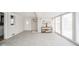 A bright, airy living room with tiled flooring, a console table, and access to outside at 208 Northshore Blvd, Anderson, IN 46011