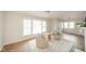 Cozy living room featuring wood floors, bright windows, and comfortable seating at 208 Northshore Blvd, Anderson, IN 46011