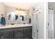 Well-lit bathroom featuring a double sink vanity and elegant mirrors at 2351 N Raceway Rd, Indianapolis, IN 46234
