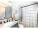 Well-lit bathroom with a modern vanity, mirror, and shower at 2351 N Raceway Rd, Indianapolis, IN 46234