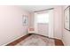 Bedroom with pink walls, chair, and an area rug at 2351 N Raceway Rd, Indianapolis, IN 46234