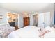 Bedroom showcasing an ensuite bathroom, hardwood floors, and neutral decor at 2351 N Raceway Rd, Indianapolis, IN 46234