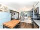 Open floor plan with modern kitchen, dining table, and view of the adjacent Gathering room at 2351 N Raceway Rd, Indianapolis, IN 46234