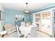 Cozy dining area featuring a modern chandelier, table with chairs, and sliding glass door to the outside deck at 2351 N Raceway Rd, Indianapolis, IN 46234