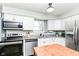 Bright kitchen with stainless steel appliances, granite countertops, and ample cabinet space at 2351 N Raceway Rd, Indianapolis, IN 46234