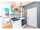 Laundry room with gray walls, washer and dryer, shelves and a decorated door at 2351 N Raceway Rd, Indianapolis, IN 46234