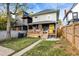 Spacious backyard with a patio, grassy area, and a charming yellow door at 3145 N New Jersey St, Indianapolis, IN 46205