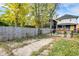 This backyard features a wooden privacy fence and a partially paved parking area with grass along the edges at 3145 N New Jersey St, Indianapolis, IN 46205