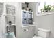 Charming powder room with open shelves, patterned storage boxes, and a toilet at 3145 N New Jersey St, Indianapolis, IN 46205
