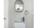 Modern bathroom featuring a glass sink and an oval mirror creating a serene and elegant space at 3145 N New Jersey St, Indianapolis, IN 46205