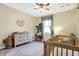 A charming Bedroom with a white dresser, wooden crib, and a light pink rug at 3145 N New Jersey St, Indianapolis, IN 46205