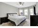 Bright bedroom showcasing a comfortable bed, soft carpet, and sheer curtains for a cozy feel at 3145 N New Jersey St, Indianapolis, IN 46205