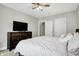 Neutral bedroom with bed, carpet, ceiling fan, TV on dresser, and closet access at 3145 N New Jersey St, Indianapolis, IN 46205