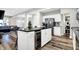 Open concept kitchen showcasing a wine cooler, island with bar stools and stainless steel appliances at 3145 N New Jersey St, Indianapolis, IN 46205