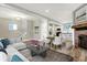 Bright living room with hardwood floors, fireplace, dining area, and open access to kitchen at 3145 N New Jersey St, Indianapolis, IN 46205