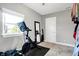 Walk-in closet featuring a Peloton stationary bike, natural light, and organized storage space at 3145 N New Jersey St, Indianapolis, IN 46205