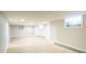 This basement features laminate flooring, bright lighting, and glass block windows, offering a modern aesthetic at 44 Kessler Blvd W Dr, Indianapolis, IN 46208