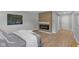 Relaxing bedroom featuring an electric fireplace, wood flooring, and a sliding door at 44 Kessler Blvd W Dr, Indianapolis, IN 46208