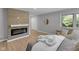 This bedroom features an accent wall fireplace and a cozy chair beneath a window offering natural light at 44 Kessler Blvd W Dr, Indianapolis, IN 46208