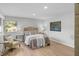 Cozy bedroom featuring soft bedding, wood flooring, and ample natural light at 44 Kessler Blvd W Dr, Indianapolis, IN 46208