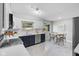 Well-lit kitchen with white cabinets, stainless steel appliances, and a cozy dining area at 44 Kessler Blvd W Dr, Indianapolis, IN 46208