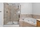 Bright bathroom with marble-tiled shower and tub at 450 E Ohio St # Apt 118, Indianapolis, IN 46204