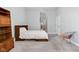 Spacious bedroom with hardwood furniture, soft carpet, and light blue walls for a calm environment at 450 E Ohio St # Apt 118, Indianapolis, IN 46204