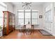 Inviting dining area features a large window, stylish lighting, and a wood cabinet for elegant storage at 450 E Ohio St # Apt 118, Indianapolis, IN 46204
