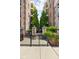 Gated entrance to the building featuring a brick facade and manicured flowerbeds and landscaping at 450 E Ohio St # Apt 118, Indianapolis, IN 46204
