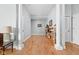 Hallway featuring hardwood floors, decorative columns, and a built-in bookcase at 450 E Ohio St # Apt 118, Indianapolis, IN 46204