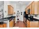 Efficient kitchen features wood cabinets, black countertops, stainless steel appliances and corner shelving at 450 E Ohio St # Apt 118, Indianapolis, IN 46204