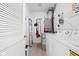 Functional laundry room with a washer, dryer, and shelving units at 450 E Ohio St # Apt 118, Indianapolis, IN 46204