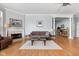 Living room featuring a fireplace, hardwood floors, and an open floorplan at 450 E Ohio St # Apt 118, Indianapolis, IN 46204