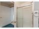 Bathroom featuring a glass enclosed shower-tub, and linen storage at 518 E College Ave, Brownsburg, IN 46112