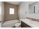 Bathroom with a tiled shower-tub, modern vanity, and decorative tile accents at 518 E College Ave, Brownsburg, IN 46112