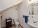 Bathroom featuring a single sink, commode, and practical storage solutions at 518 E College Ave, Brownsburg, IN 46112